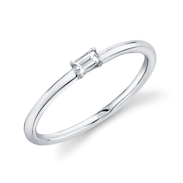 SC22004976_1200x The Emma Ring is a minimalist silver band featuring a small, rectangular baguette-cut diamond set horizontally, displayed against a white background.